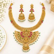 Gold-tone finish with ruby-red and green stonesLakshmi Temple Jewellery